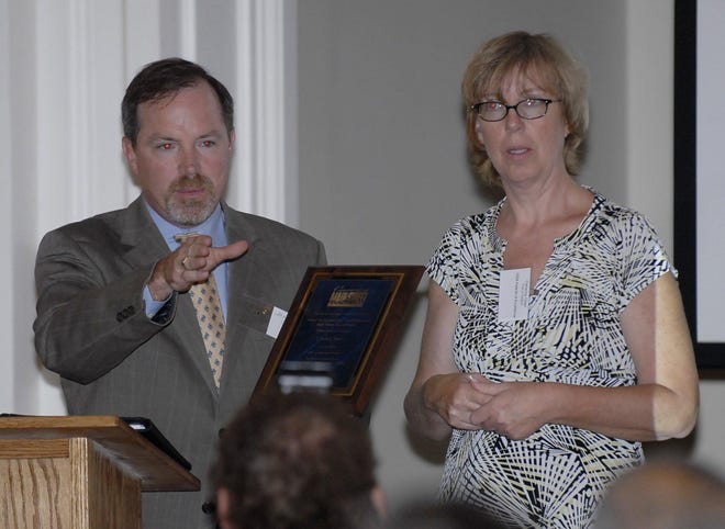 Catherine Osten of Sprague accepts the CL&P Award for Outstanding Contributions to Main Street Revitalization Monday, on behalf of her sister, Linda Osten. John O’Toole of CL&P presents the award during the 2008 Awards of Excellence held at the Wauregan Ballroom in Norwich.