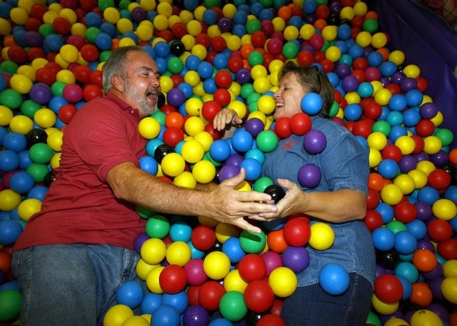 Gary and Barb Murphy lounge in a children's play area Tuesday at Our Fun Factory on Southwest 27th Avenue. The Murphys, who bought the play place in 2000 and sold it in 2003, have reopened it again.