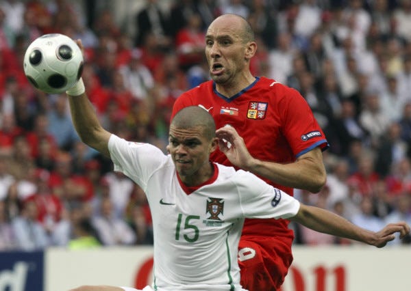 Portugal's Pepe, left, and Czech Republic's Jan Koller vie for the ball during the group A match between Czech Republic and Portugal in Geneva, Switzerland, Wednesday, June 11, 2008, at the Euro 2008 European Soccer Championships in Austria and Switzerland. Portugal defeated Czech Republic 3-1. (AP Photo/Luca Bruno)