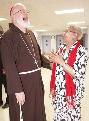 Cardinal Sean O'Malley,:Archbishop of Boston, and Vinny Andrade of Middleboro have a laugh together Sunday at Saints Martha and Mary Church in Lakeville. Cardinal O'Malley was at the church to help celebrate its 50-year anniversary as part of the Archdiocese of Boston.