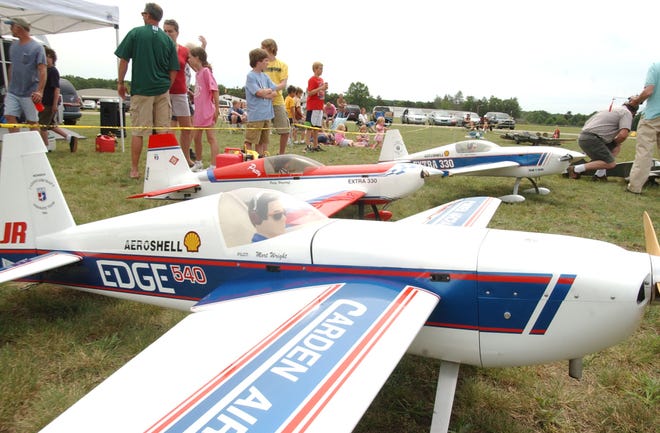 Spectators look over a selection of radio-controlled airplanes at the Tulip City Air Force model airplane club’s fourth annual Big Bird Classic Friday afternoon.