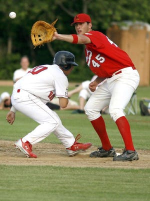 Orleans first baseman Nate Freiman catches the ball from the pitcher and tries to tag out Y-D's Gunner Glad.