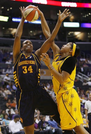 Los Angeles Sparks' Candace Parker, right, blocks Connecticut Sun's Tamika Raymond (34) in the first half of a WNBA basketball game, Friday, June 13, 2008, in Los Angeles.