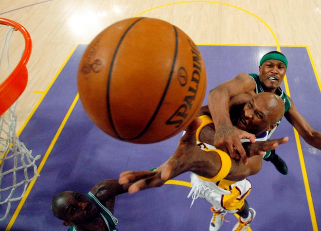 Los Angeles Lakers forward Lamar Odom is fouled by Boston Celtics forward James Posey, top, in the fourth quarter of Game 5 of the NBA basketball finals against the Boston Celtics Sunday, June 15, 2008, in Los Angeles. The Lakers won 104-98.