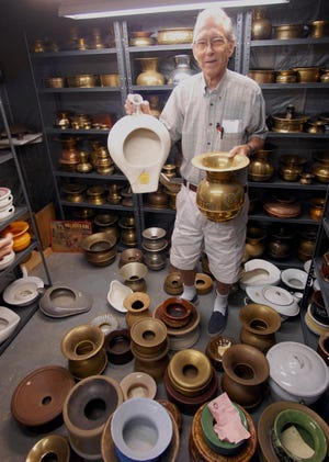 Jim Kinner, 71, shows some of his 300 spitoons and chamber pots he collected Monday, June 2, 2008 at his Jewett City home.