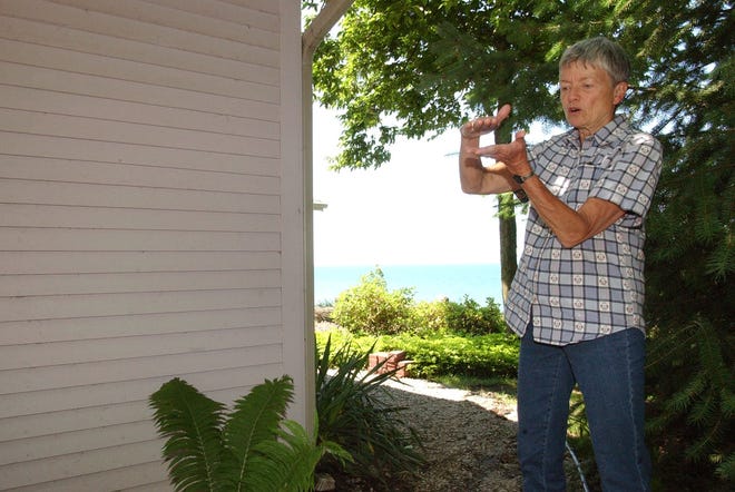 Dennis R.J. Geppert/The Holland Sentinel
Sally koning describes the amount of water that surrounded her lake front home during heavy rains on Saturday night. The Koning's decided to leave there home that they felt was in threat on the 45 foot bluff overlooking Lake Michigan.