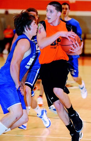 Tuslaw’s Shelby Combs, left, tries to defend Massillon’s Gio Caracillo during a summer league game last week.