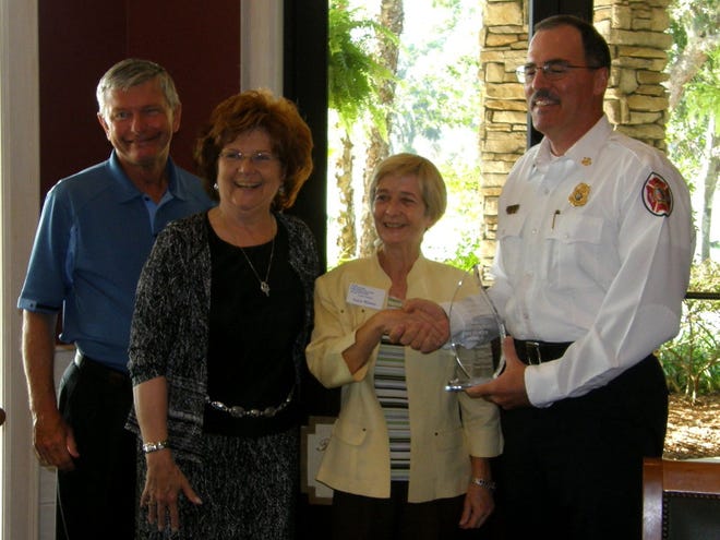 Chief Stuart McElhaney, right, receives a Communicator of the Year Award on behalf of Marion County Fire Rescue at the Country Club of Ocala on Thursday. With McElhaney, from left, are Gen. Pat Howard, Marion County administrator; Barbara Fitos, Marion County commissioner; and Anita Winter, president, Ocala chapter of the Florida Public Relations Association.