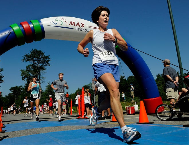 Runners cross the finish line during the 5th Annual Sharon Timlin Memorial 5k at Hopkinton High School Saturday. The event is in memory of Red Sox pitcher Mike Timlin’s mother Sharon who died from the disease in 2001 at the age of 61. Over a thousand runners finished the race