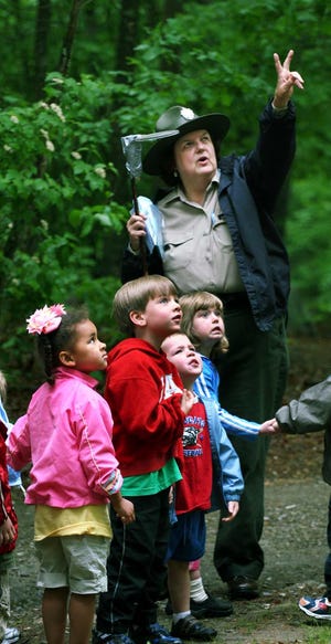 Pre schoolers go on a birding adventure at Borderland State Park with park interpreter Christine King, who
points out a nest high in a pine tree.