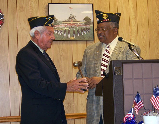 Augustin Luna accepts the gavel as commander of Babin - Haynes Post 98 American Legion from past department commander Raymond Walters during the annual installation of officers at the post Tuesday night.