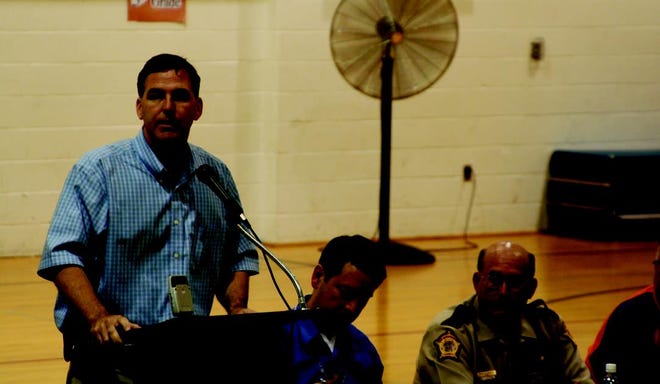 State Sen. John Sullivan speaks to flood victims Thursday night at West Central High School. Emergency management officials from the local, state and federal levels were on hand to answer questions and provide information to those affected by the flood, some of whom have yet to return to their homes.