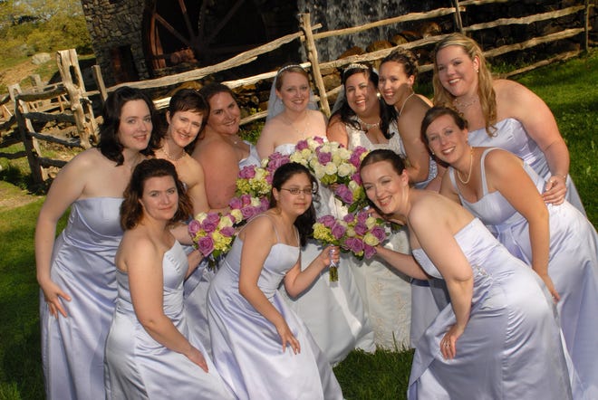Susan Bushey and Jennifer Brown laugh with their bridesmaids after their May 17, 2008 wedding. Back row, left to right, are Laurel Aylesworth, Joyce Vyriotes, Cara King-Anderson, Jen, Susan, Audra White and Megan MacBey. Front row, Kristin Parker, Mary-Catherine Rivera, Kate Weldon LeBlanc and Alexis Kerr. The couple was married at the Martha-Mary Chapel in Sudbury.