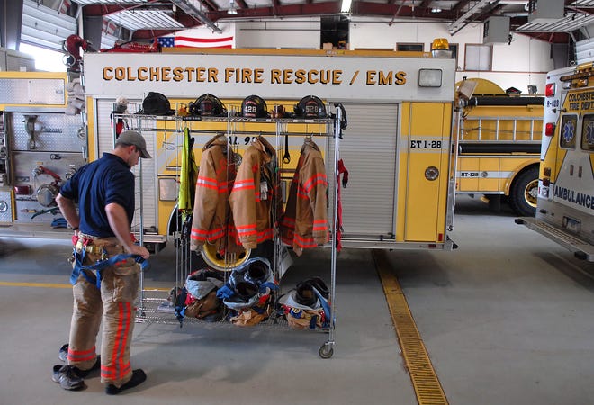6:02 p.m. - Colchester Hayward volunteer firefighter George Papp of Colchester puts on fire gear in case a call comes in.