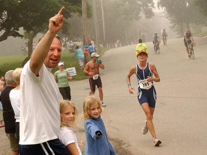 Spectators cheer on the participants in the Cohasset Triathlon.