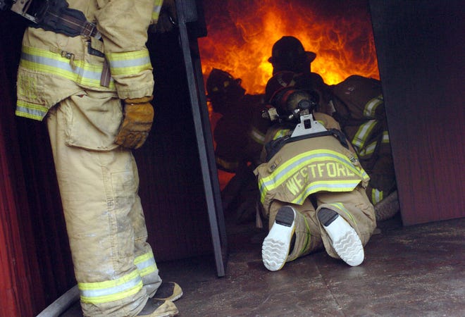 Firefighters enter a flashover drill Thursday.
