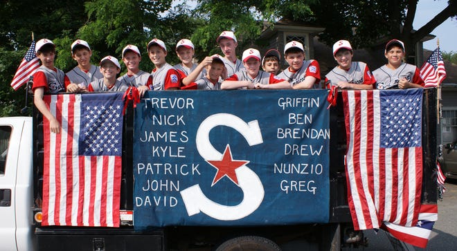 The Swampscott All-Stars get a free ride during the recent parade. From left to right, this year’s All-Stars are Nick Agresti, Trevor Massey, David Reichert, Greg Collier, Griffin Hunt, Drew Gentile, Nunzio Morretti, Patrick Burkett, Ben Faulkner, John King, James Collins, Kyle Waters, Brendan McDonald.