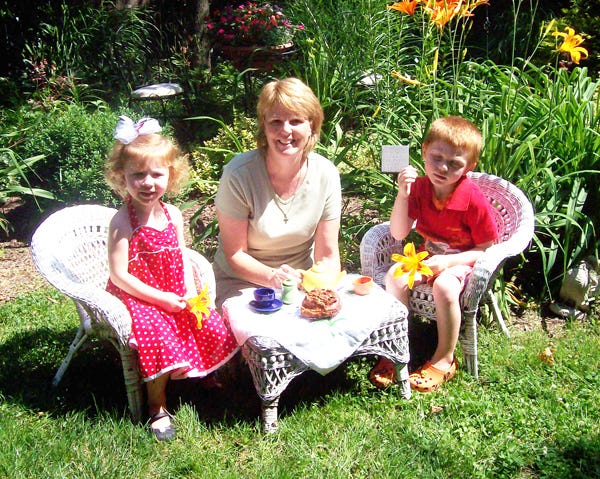 Mary Beth Farber, center, enjoys a tea party with her grandchildren Laila, 3, and Max, 5.