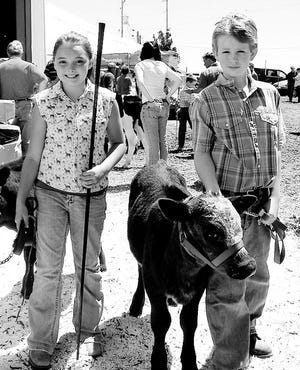 Katie Miller of Cambridge, left, and Logan Martens of Lynn Center were named the record book winners of the 4-H Bucket Calf Show Saturday, June 28, at the Henry County Fair. Miller won the division for 10 and under, while Martens won the older class.