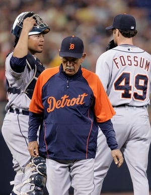 Detroit Tigers manager Jim Leyland, center, leaves the mound after putting in relieve pitcher Casey Fossum, right, to replace starter Eddie Bonine in third inning of a baseball game Wednesday, July 2, 2008 in Minneapolis. At left is catcher Dane Sardinha. The Twins won 7-0.