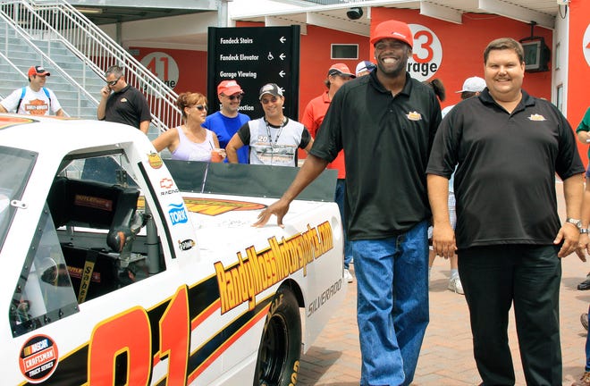 New England Patriots wide receiver Randy Moss, left, poses for a photo with NASCAR Craftsman Truck Series owner David Dollar after it was announced that Moss had bought 50 percent of the racing team during a news conference at Daytona International Speedway in Daytona Beach, Fla. The team will be called Randy Moss Motorsports beginning with the July 19, 2008 race in Kentucky. (AP Photo/Terry Renna)