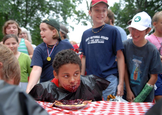 Sheldon Marcotte, 14, of Woodstock takes a break from a pie eating contest to check out his competition during the annual Fourth of July Jamboree at the East Woodstock Congregational Church Friday. Marcotte won messiest eater.