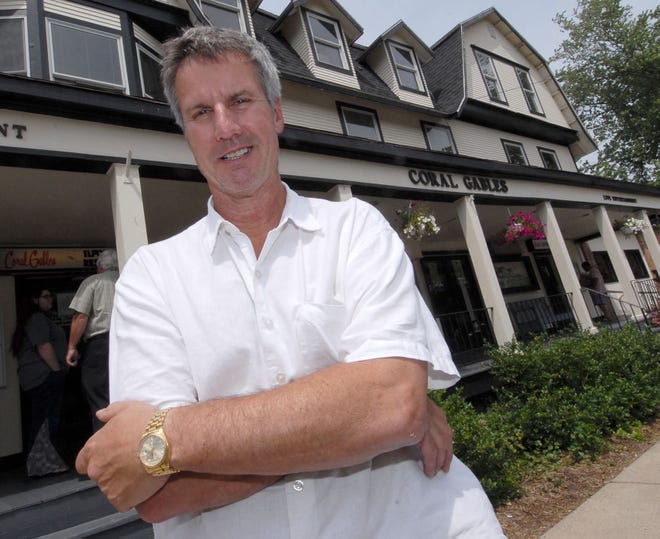 Coral Gables owner Mike Johnson poses in front of his Saugatuck restaurant Wednesday.