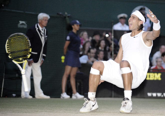 Rafael Nadal collapses to the court after beating five-time champion Roger Federer at Wimbledon.
