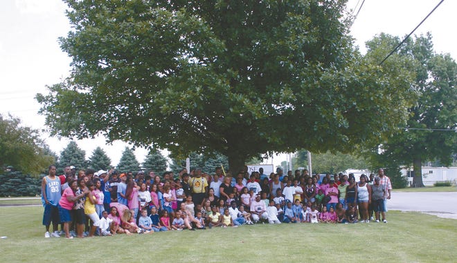 About 150 of the more than 400 members of the Bailey family who were in Monmouth this weekend for a family reunion gather for a group picture.