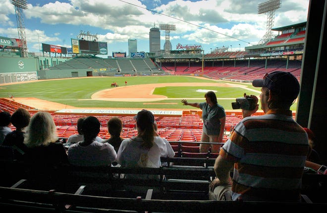 Guide Kuri DesJardins gives a historical perspective on Fenway Park to visitors on on Old Town Trolley Tour. The company has been hosting "Lunch on the Green Monster" tours since May.