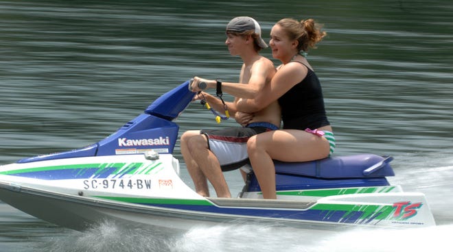 Cody Willing and his girlfriend, Breanna Thomasson, both 16 and from North Augusta, beat the heat and humidity Thursday while taking a brisk ride on a personal watercraft on the Savannah River.