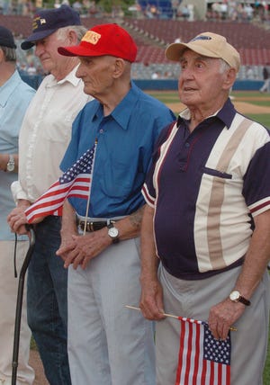 World War II veterans Dan Ponder, left, Arthur Gaucher and John P. John, all of Norwich, are honored with other veterans Friday, July 11, 2008 before a game at Dodd Stadium in Norwich.