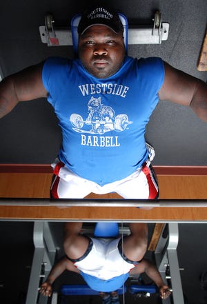 Power lifter Rob McCray is one of a fistful of men to bench press 900 pounds.