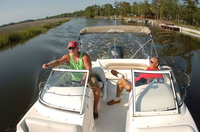 Joe Taylor (left) and Dave Pelizzari, both residents of Sunset Harbor, ride along the Lockwood Folly River on Sept. 6, 2007.