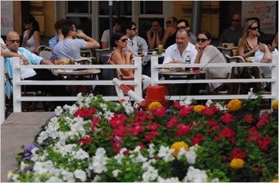 People ate and drank at one of Moscow’s summer cafes, which were built to take advantage of warm days and to shelter patrons from bad weather.