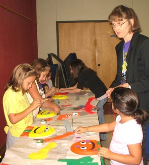 Library staff Elizabeth Richardson and Mary Mabile demonstrate the art of making "Rainbow Fish" during a Make and Take Craft at the Ascension Parish Library's Donaldsonville Branch Wednesday. The library offers crafts and programs throughout the summer.
