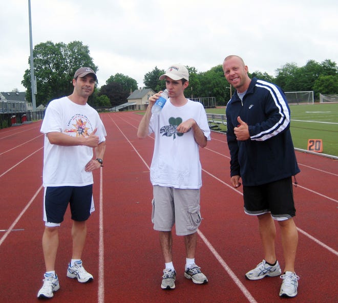 Andy Mola, 26, trains with Lowell athletes Jack Silva, left, and Scott Hagan, owner of Classic Fizeek for the sixth annual Marcia Lemkin 5K Race in Lowell on Aug. 24.
