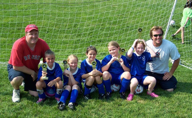 (Left to right) Coach Dave Picher, Kelly Golini, Lindsay Harris, Maggie Penta, Isabelle Picher, Lillian Holden and coach Jamie Holden of Tewksbury take the Under-8 Girls Play Soccer 3vs3 Tournament in Northboro on Saturday.