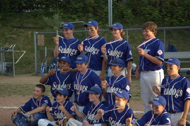 Members of The Seadogs 12U Team display their medals after winning the 12U title at the New England AAU Championships.