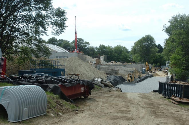 The construction site of the Weld Hill Research and Administration Building as approached from the Bussey Street side on July 11. Several walls have been installed as well as nearly all of the geothermal wells at the site. On the left side, the large mound of dirt is visible, all of which came from the existing hill. This project has no materials leaving the site--piles of dirt are moved around to keep it all on-site, while trees that were removed have been chipped to serve as mulch once the landscape work is done toward the end of the project, estimated to be complete in the fall of 2009. The building is also applying to be LEED certified on the silver level, but may move up to gold or platinum in the future.