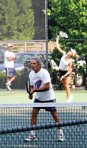 Miranda Duggan serves while her father Will is focused at the net during Sunday’s ‘A’ Mixed Doubles final at Mount Shasta Resort.