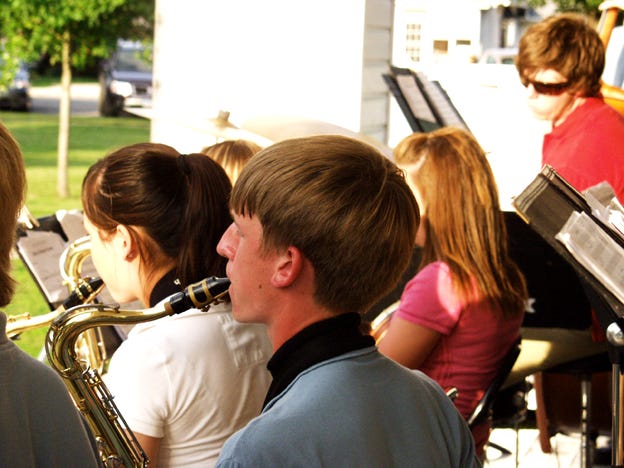 During “St. Louis Blues,” Orion High School student Jim Hills, front, plays tenor saxophone with the Bix Beiderbecke Memorial Youth Jazz Band on Wednesday, July 9, in the Central Park band shell, Orion. The performance preceded the Orion Community Band concert and the “Field of Dreams” showing. Hills and the youth band will play at the Bix Beiderbecke Memorial Jazz Festival later this month in Davenport.