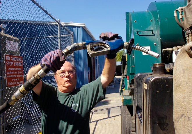 Billy O’Connell, Heavy Equipment Operator with Randolph DPW for 38 years, puts diesel into a town-owned vehicle.