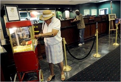 Mary Milton, left, of Trapp, Md., treats herself to complimentary popcorn at Easton Bank and Trust in Easton, Md.