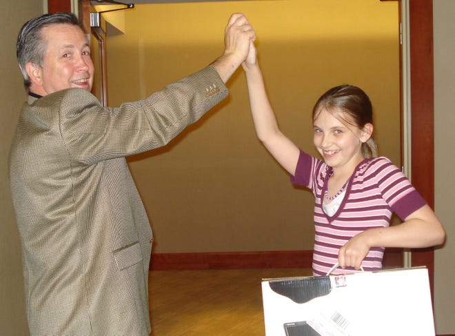 Fiona Gorry-Hines high-fives Michael Jorgensen, general manager of The Westin Copley Place Boston, after winning a Dell computer.