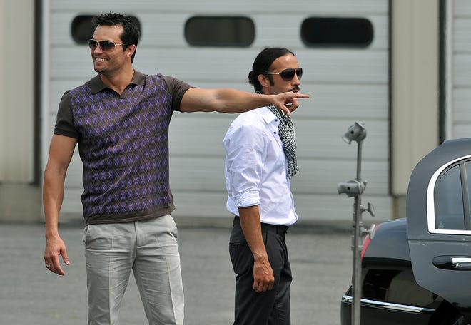 Actors Scott Elrod (left) and Carlos Leon prepare to film a scene for the Nutressa Movies production of "Tricks Of A Woman" at Accent Limo in Milford, Saturday.