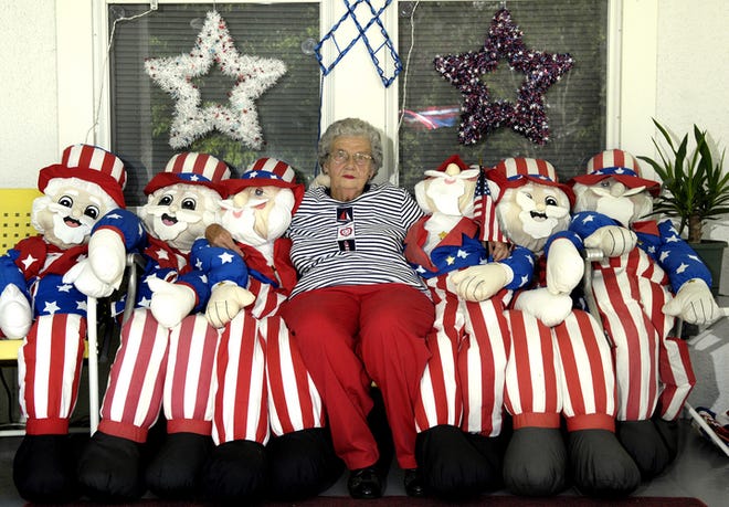 Frances Peck, 75, sits with several of the Uncle Sam dolls that she uses to decorate her North Augusta home for the Fourth of July every summer. She also has 15 Easter bunnies and 10 Christmas trees.
