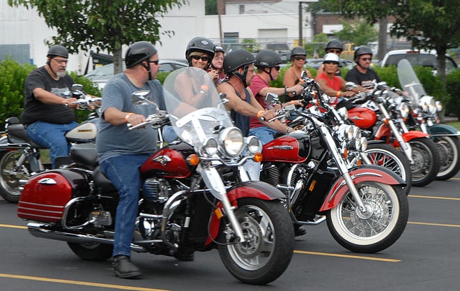 The MetroWest chapter of the Harley Owners Group lines up outside Paramount Harley-Davidson on Waverley Street in Framingham on Sunday. They rode in a poker run to benefit Holliston's Breezy Hill Farm, which specializes in helping people with developmental, physical and social disabilities.