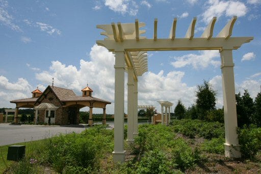 An elaborate entrance, including a gatehouse and trellis, is shown at the entrance to JB Ranch on Southwest 60th Avenue in Ocala, on Friday. Lennar Homes, which planned to develop the retirement community, has backed out.
