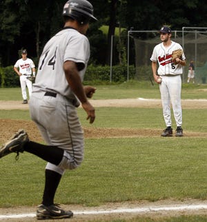 Northborough pitcher Andy Bower (right) looks on as Main South's Darnell McGee rounds the bases after hitting a home run.